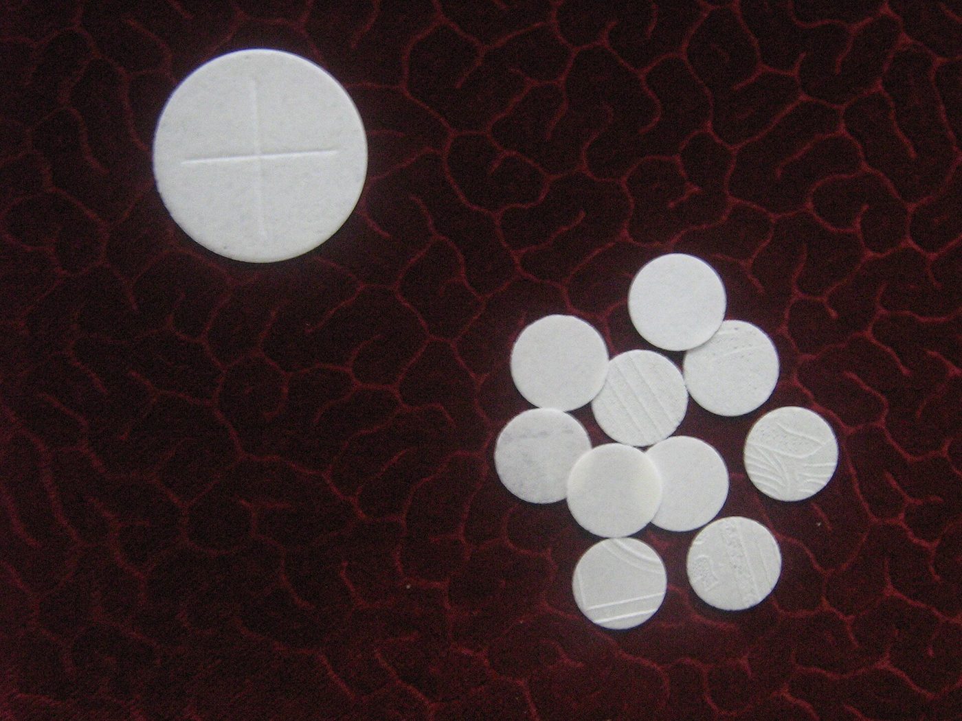 White hosts on a dark red background